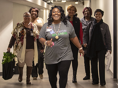 Makeba Smith-Harris, billing specialist at UMMC’s Clinton Billing Office, leads a group of colleagues on a wellness walk.